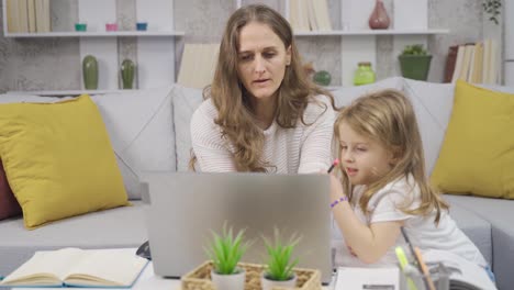 Businesswoman-works-in-her-home-office-and-takes-care-of-her-little-daughter.
